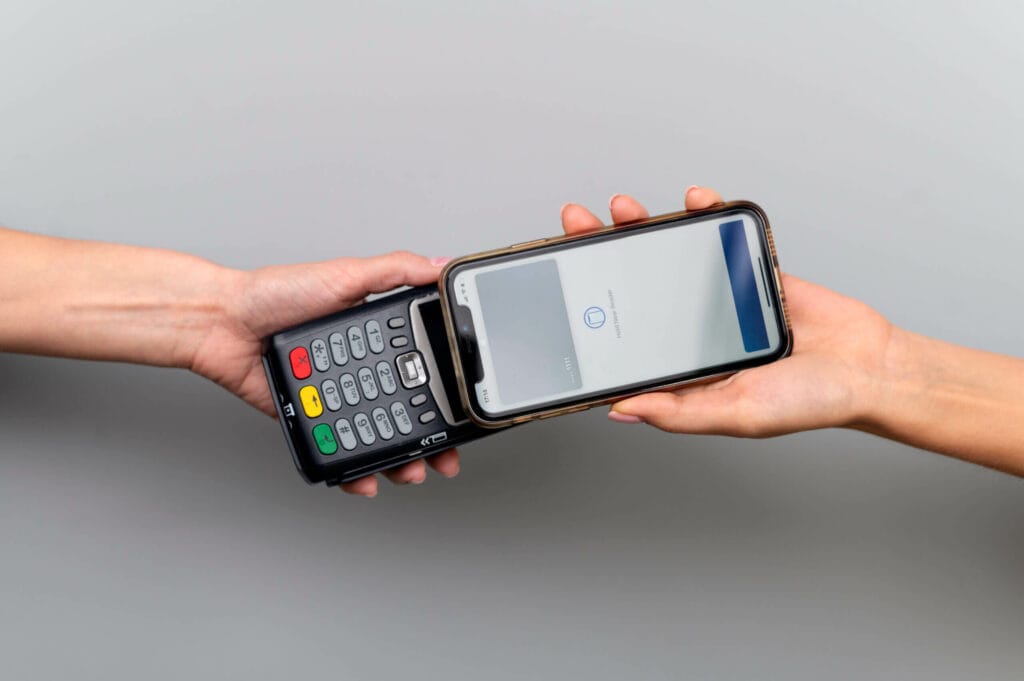 person paying with its smartphone wallet app scaled 1